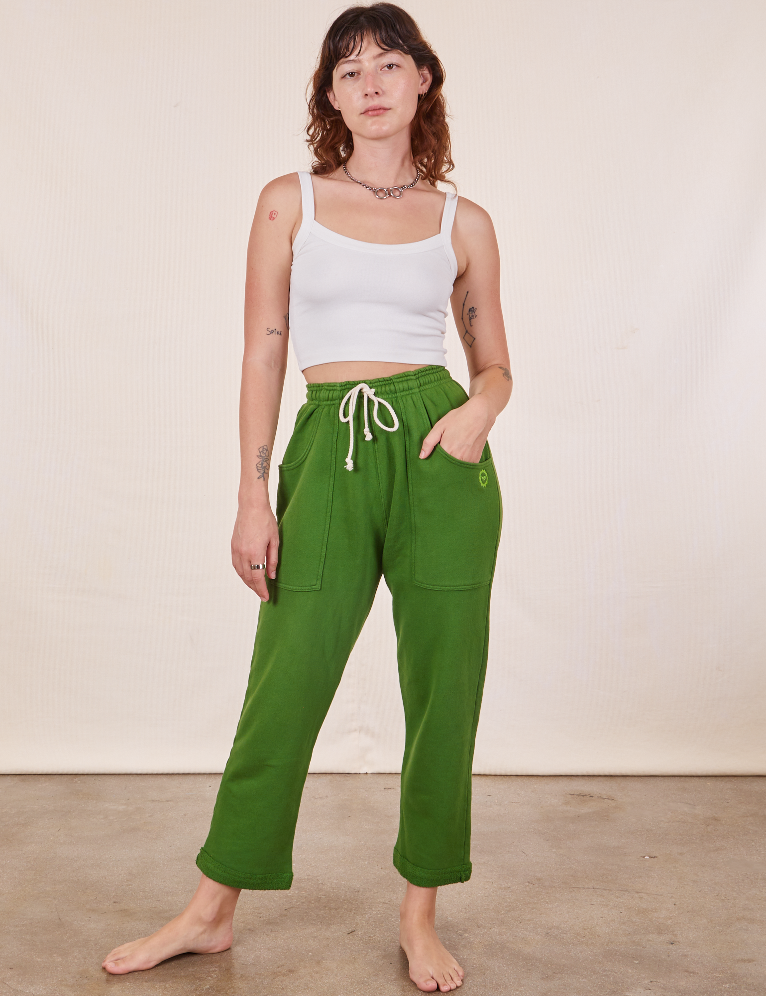 Alex is wearing Cropped Rolled Cuff Sweatpants in Lawn Green and vintage off-white Cami