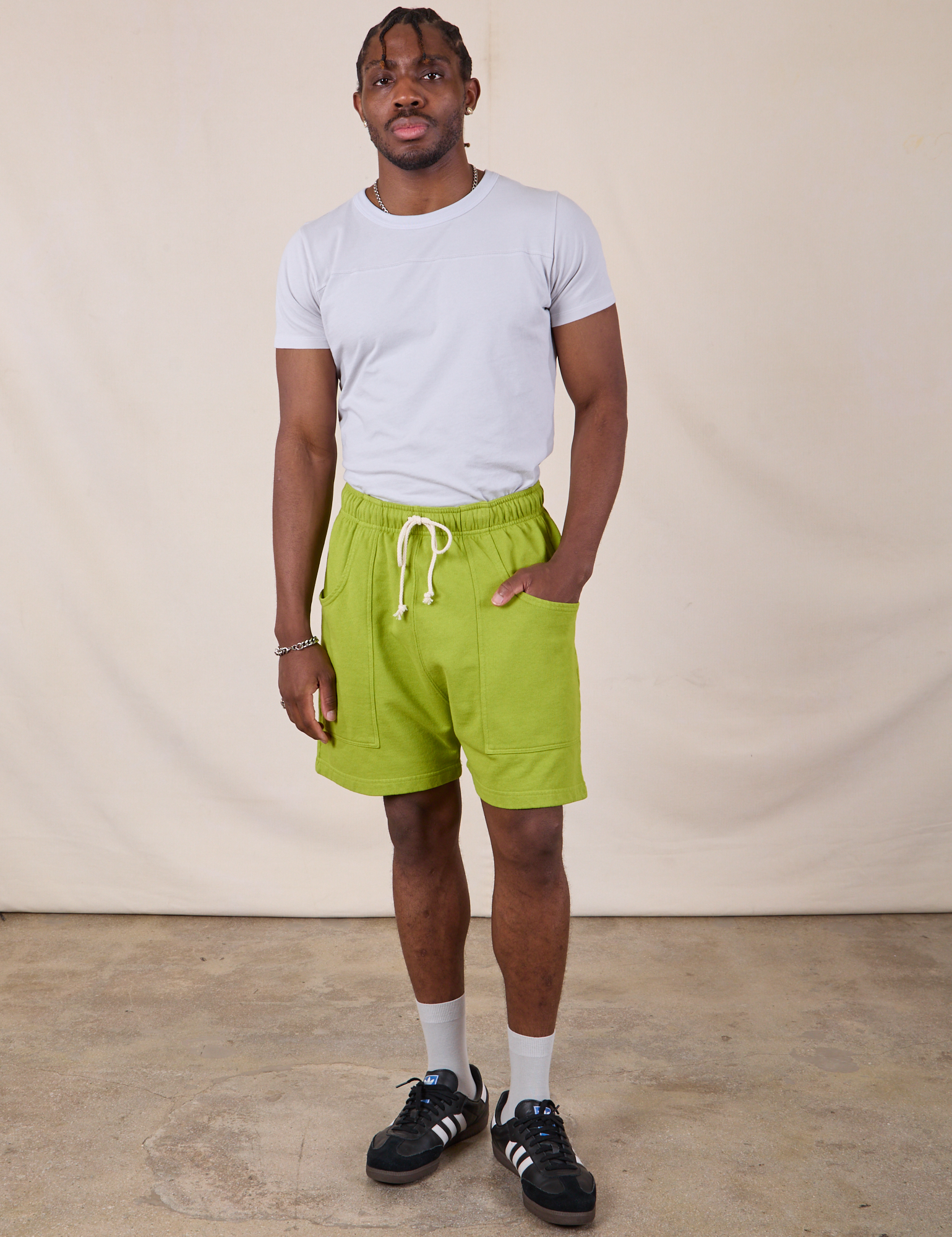 Isaac is wearing Sweat Shorts in Gross Green and Jr. Varsity Tee in Stone White