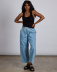 Kandia is wearing The Tank Top in Basic Black and light wash denim drop pocket pants