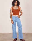 Jesse is wearing Cropped Tank Top in Burnt Terracotta paired with light washed Sailor Jeans