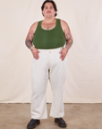 Sam is wearing Tank Top in Dark Emerald Green and vintage off-white Western Pants