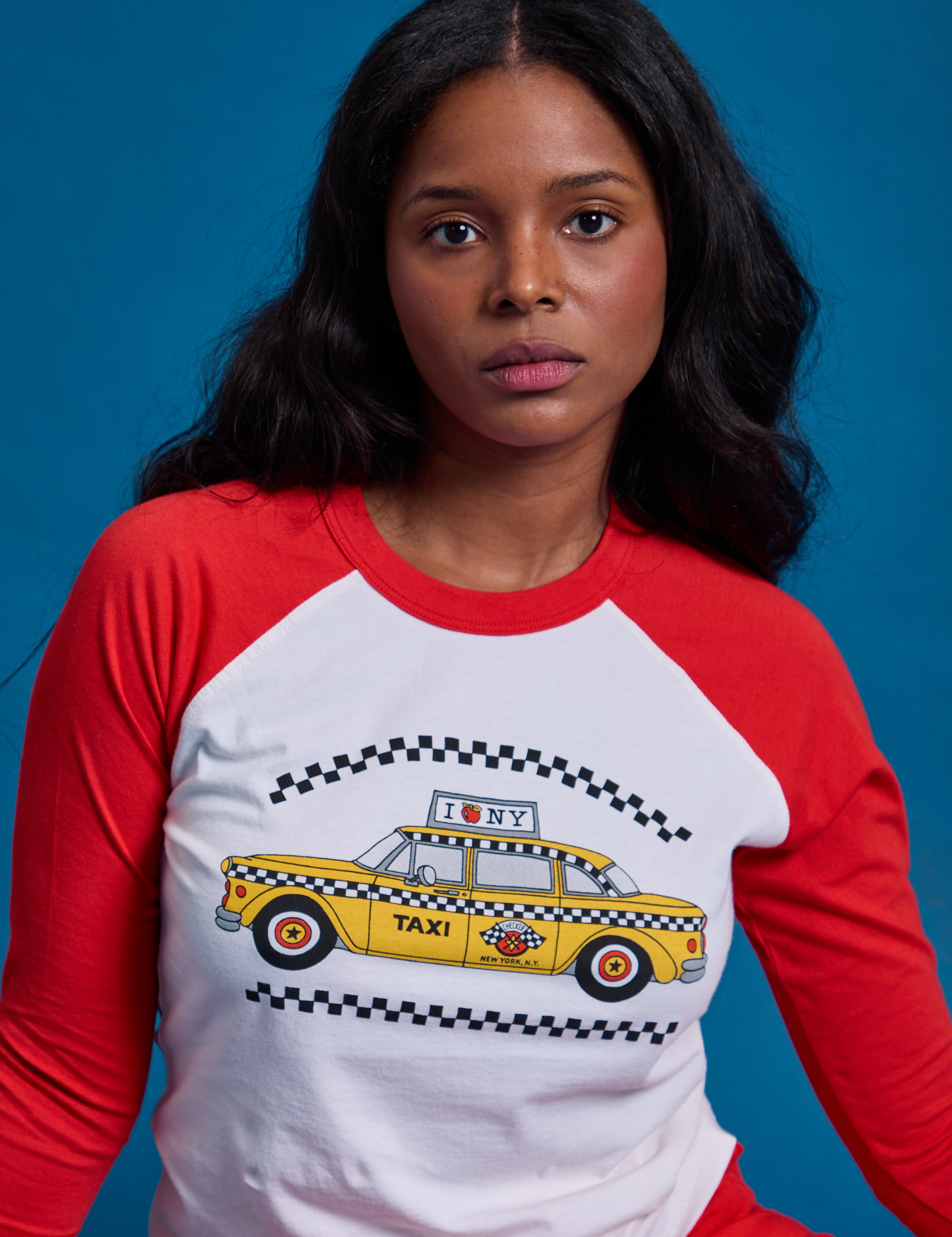 Taxi Raglan Tee in NYC with red sleeves worn by Kandia