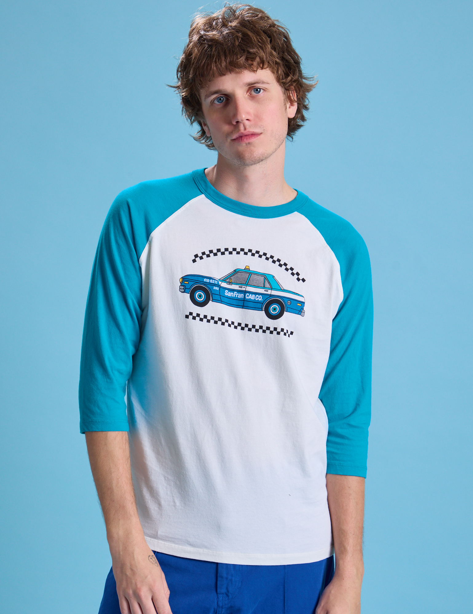 Quinn is wearing Taxi Raglan Tee in San Francisco