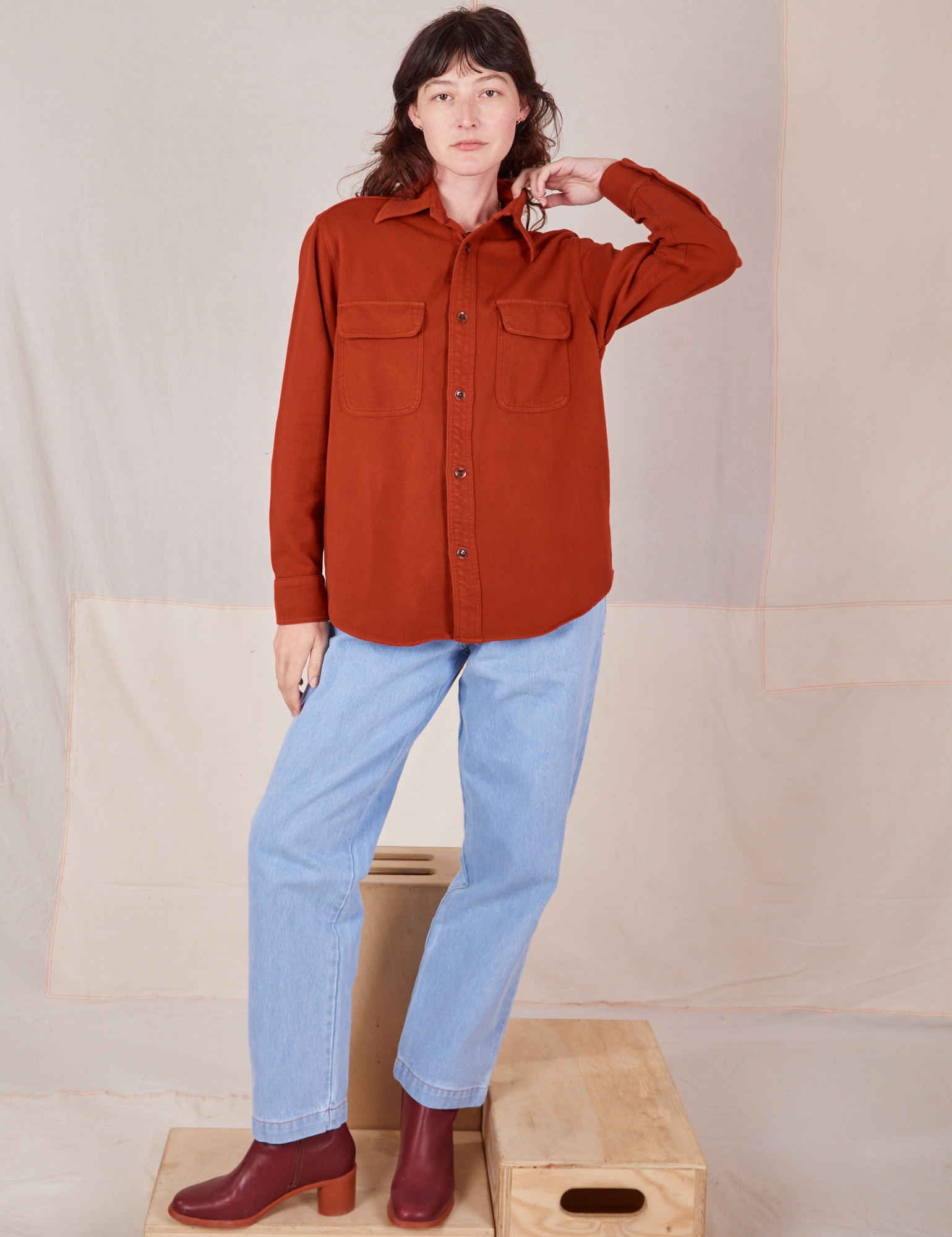 Alex is 5&#39;8&quot; and wearing P Flannel Overshirt in Paprika paired with light wash Trouser Jeans