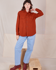 Alex is 5'8" and wearing P Flannel Overshirt in Paprika paired with light wash Trouser Jeans