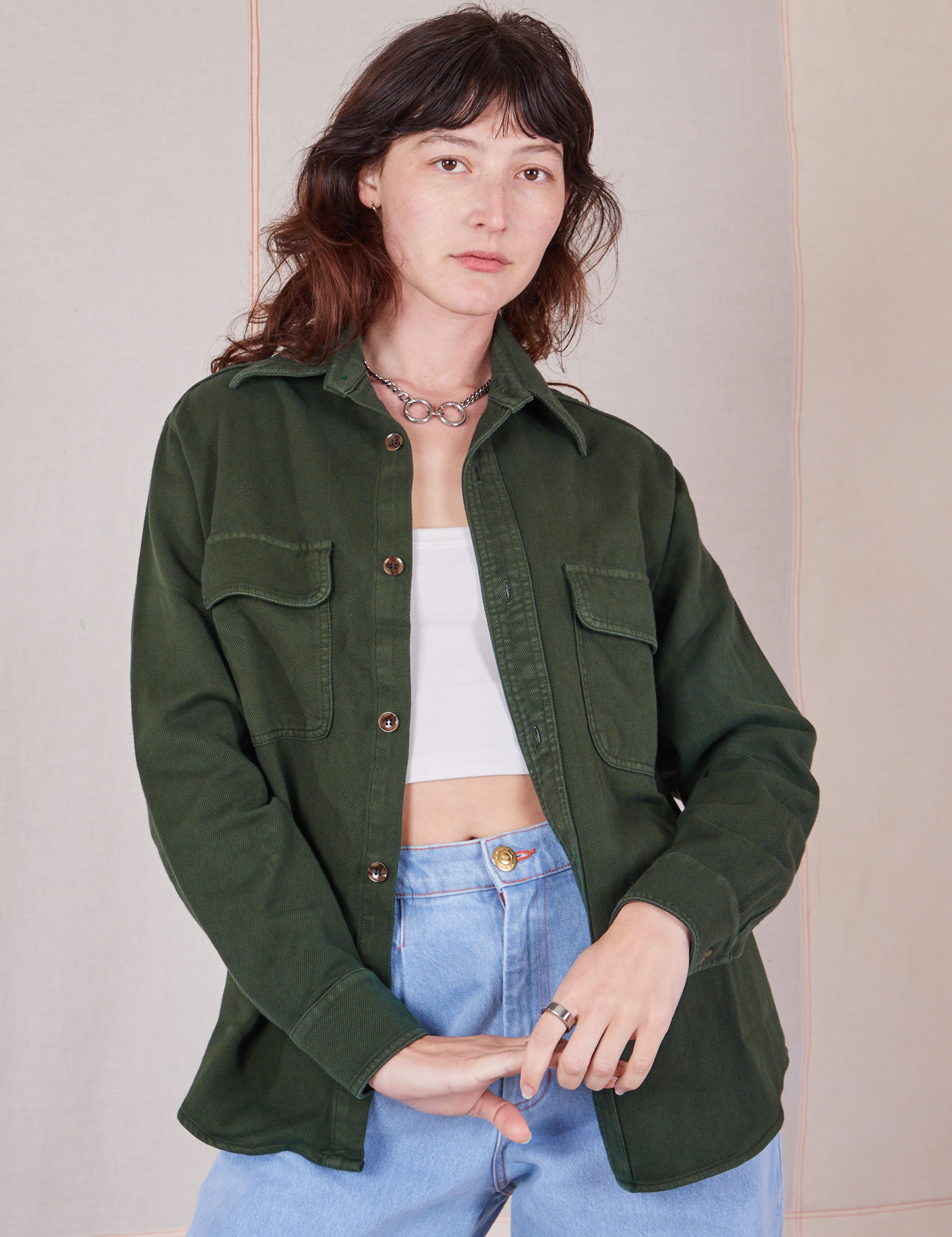 Alex is 5&#39;8&quot; and wearing P Flannel Overshirt in Swamp Green paired with vintage off-white Cropped Cami and light wash Trouser Jeans