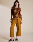 Alex is wearing Long Sleeve Baby Tee in Honey Brown paired with spicy mustard Drop Pocket Cargo Pants