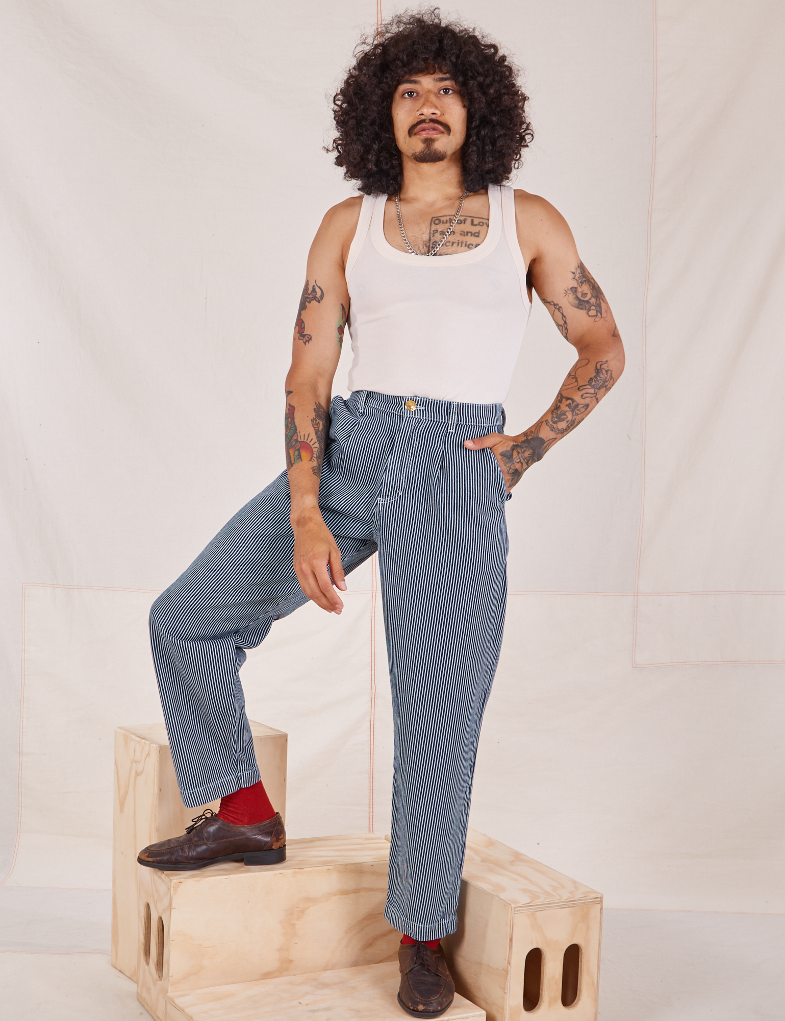 Jesse is wearing Denim Trouser Jeans in Railroad Stripe and vintage off-white Tank Top