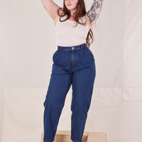 Sydney is wearing Denim Trouser Jeans in Dark Wash and vintage off-white Tank Top