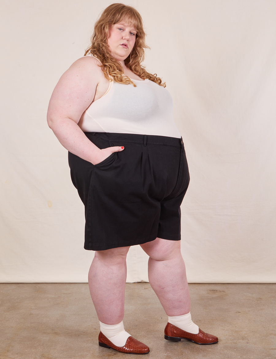Side view of Trouser Shorts in Basic Black and vintage off-white Tank Top worn by Catie