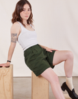 Hana is wearing Trouser Shorts in Swamp Green and Cropped Tank in Vintage Tee Off-White