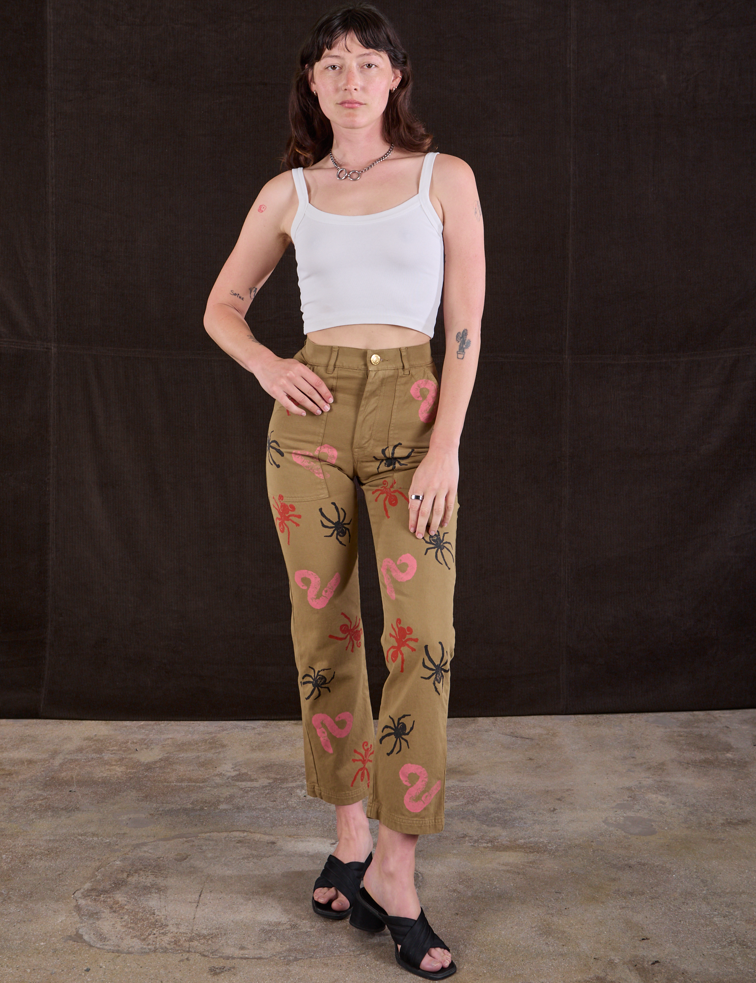 Alex is 5'8" and wearing XS 
Paintstamped Bug Work Pants in Desert Brown paired with a Cropped Cami in Vintage Tee Off-White