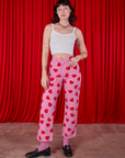 Alex is wearing Paintstamped Heart Work Pants in Bubblegum Pink and a vintage tee off-white Cami