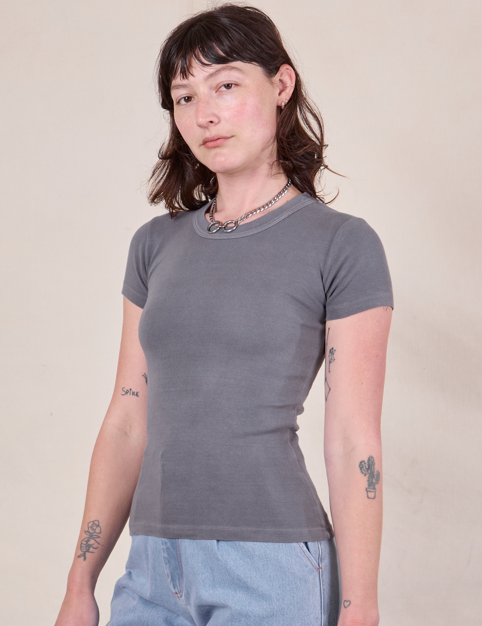 Angled front view of Baby Tee in Washed Grey worn by Alex