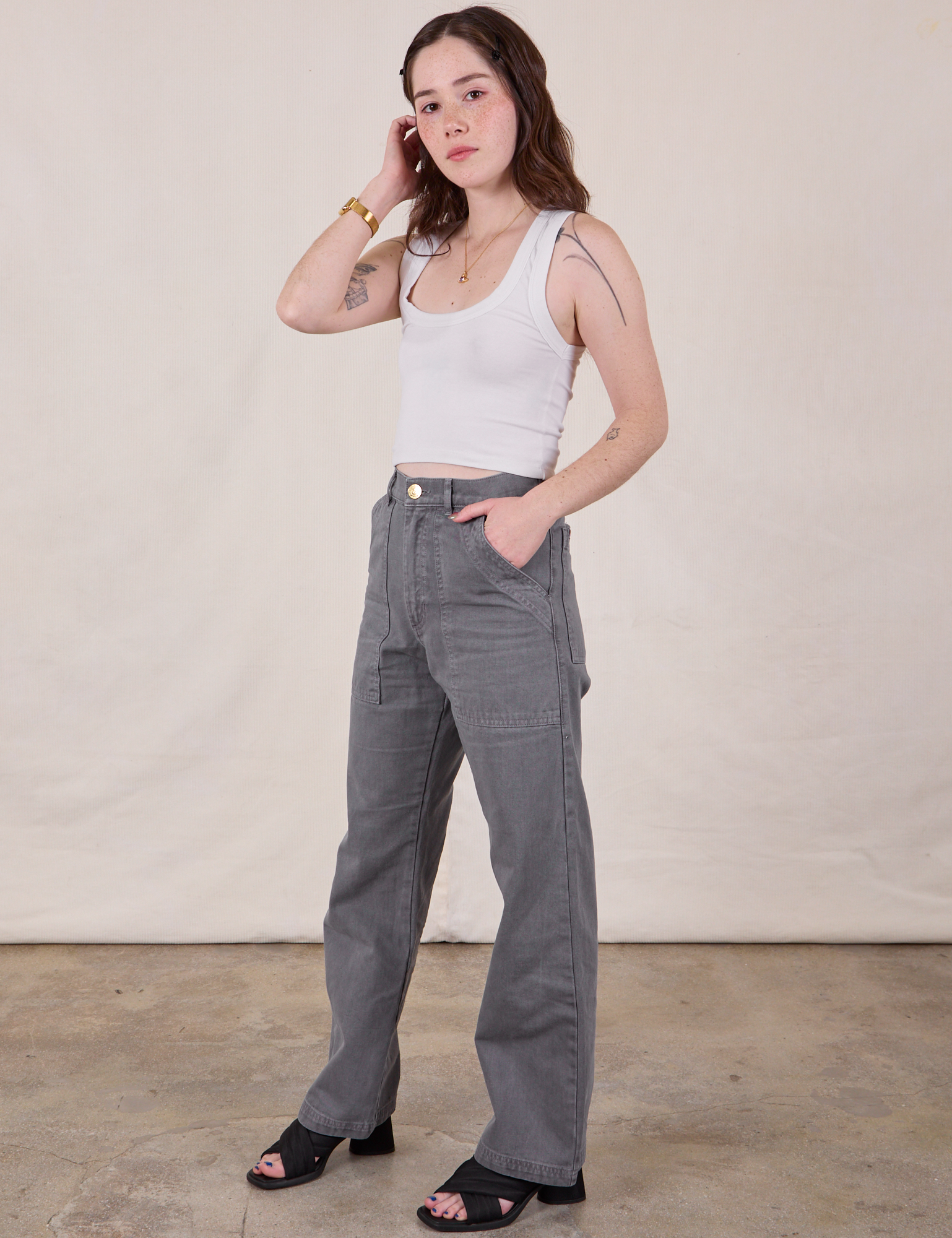 Angled front view of Work Pants in Washed Grey and Cropped Tank in Vintage Tee Off-White on Hana