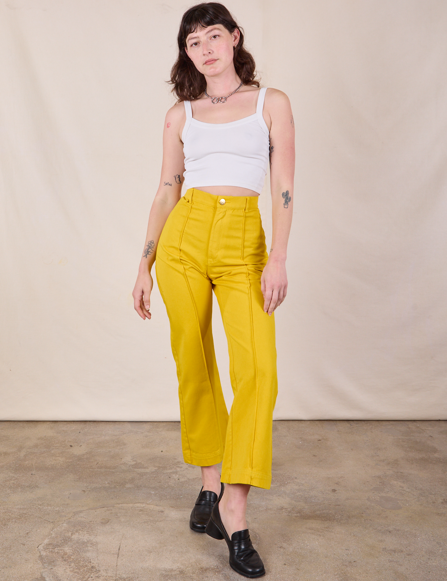 Western Pants in Golden Yellow and Cropped Cami in vintage tee off-white worn by Alex