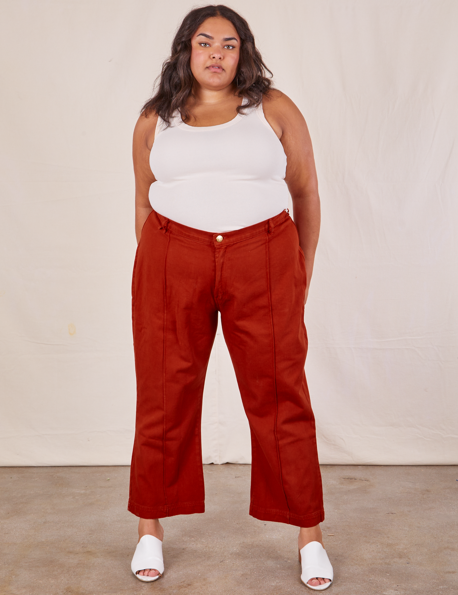 Alicia is wearing Western Pants in Paprika and a Tank Top in vintage tee off-white