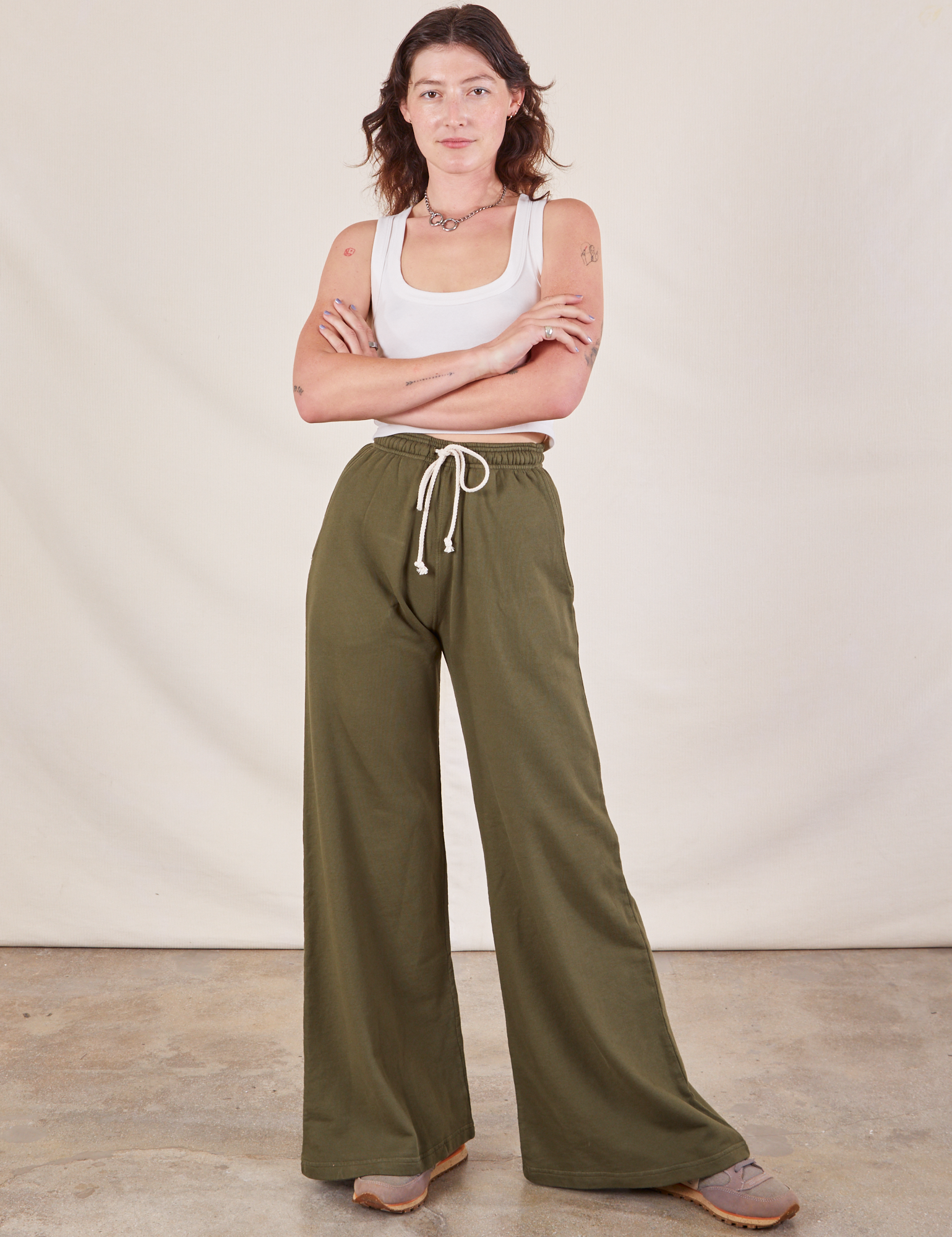 Alex is 5'8" and wearing P Wide Leg Sweat Pants in Surplus Green paired with Cropped Tank in vintage tee off-white