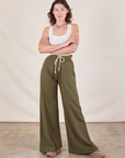 Alex is 5'8" and wearing P Wide Leg Sweat Pants in Surplus Green paired with Cropped Tank in vintage tee off-white