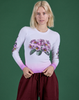 Madeline is 5’9” and wearing P Floral Long Sleeve Baby Tee in Pink