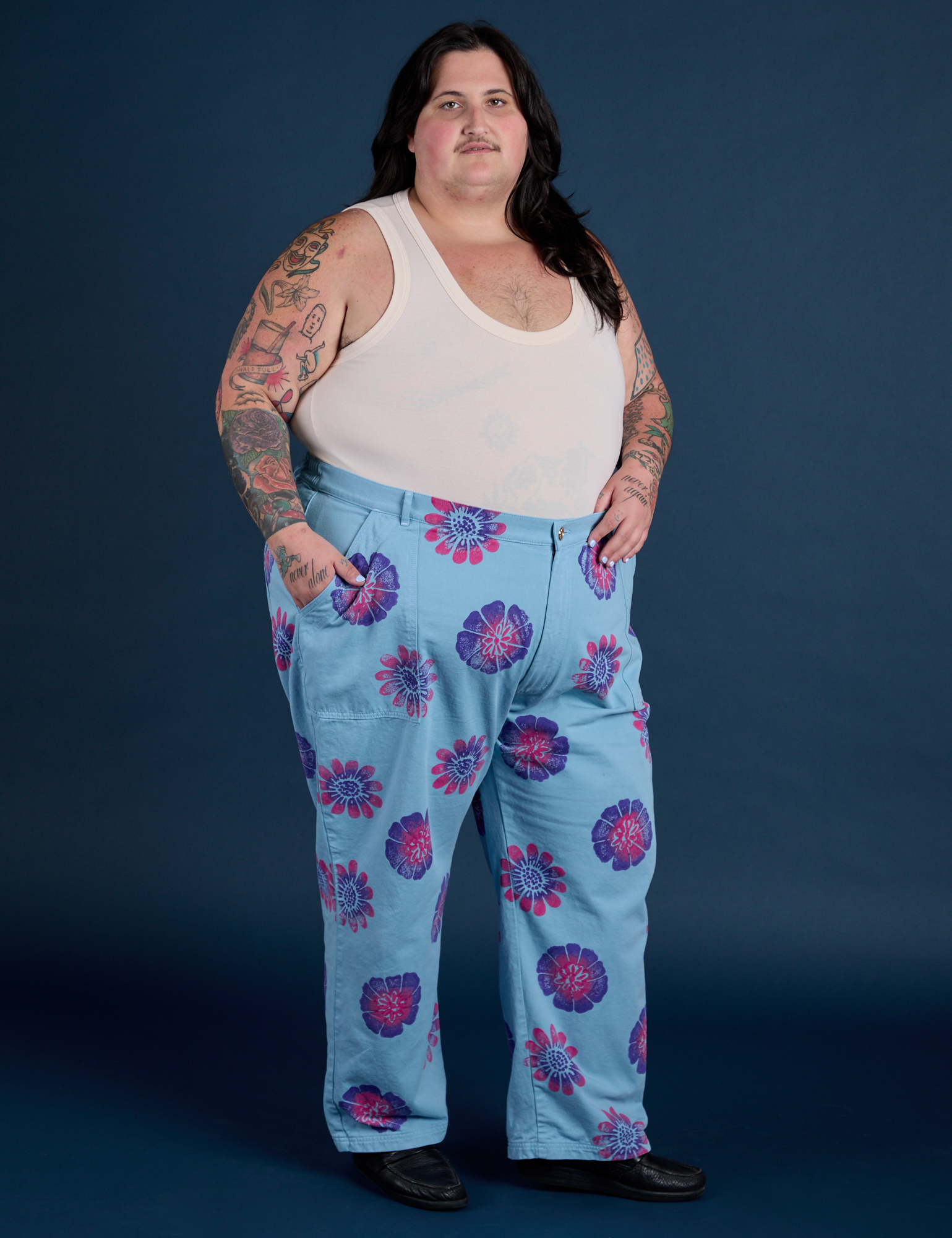 Angled front view of Floral Painted Work Pants in Blue and Tank Top in Vintage Tee Off-White on Sam