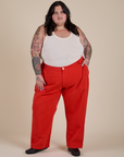 Sam is wearing Work Pants in Mustang Red and vintage tee white Cropped Tank