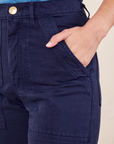 Front pocket close up of Work Pants in Navy Blue. Worn by Soraya with her hand in the pocket