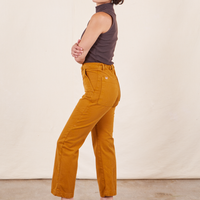 Work Pants in Spicy Mustard side view on Soraya wearing espresso brown Sleeveless Turtleneck