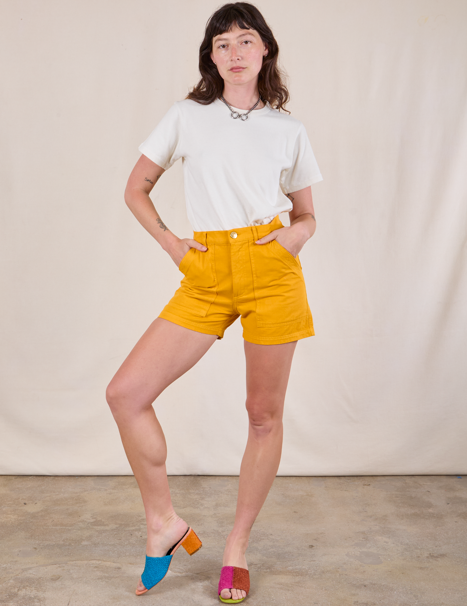 Alex is wearing Classic Work Shorts in Mustard Yellow and Burly Tee in Vintage Tee Off-White