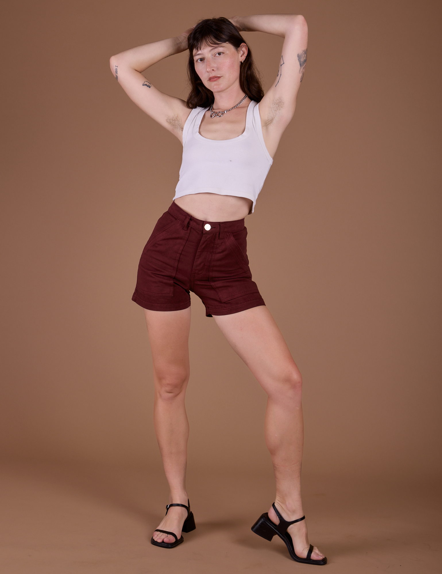 Alex is 5’8” and wearing XXS Classic Work Shorts in Red Wine paired with vintage tee white Cropped Tank