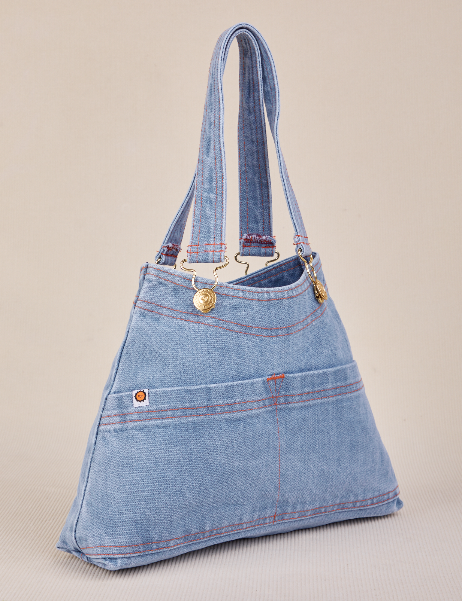 Angled view of light wash Indigo Overall Handbags