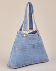 Angled view of light wash Indigo Overall Handbags