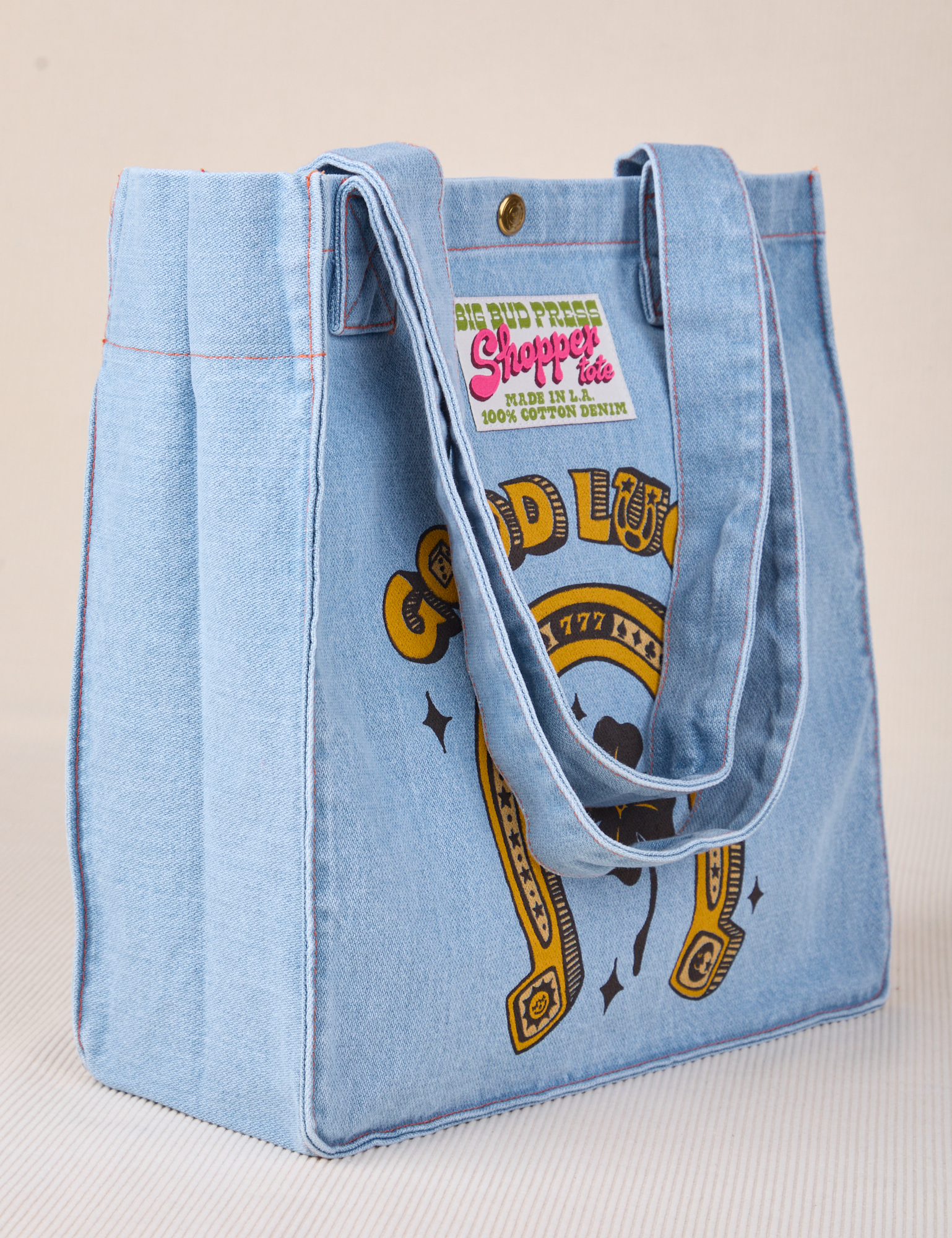 Angled view of Shopper Tote in Golden Horseshoe