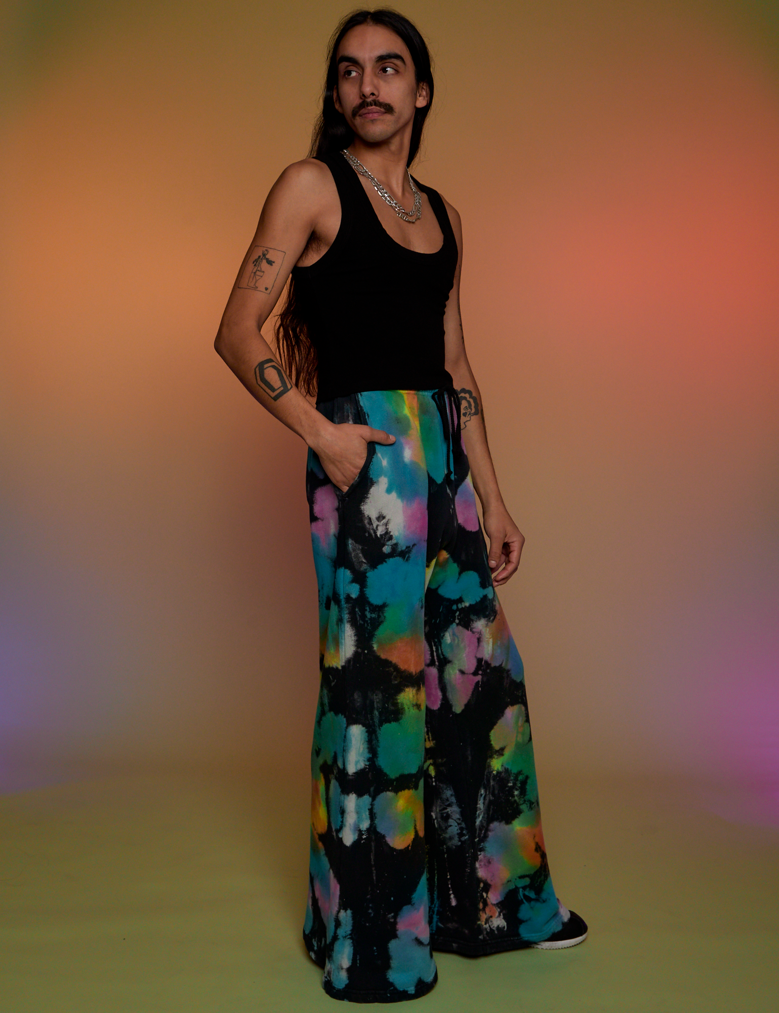 Side view of Tie Dyed Wide Leg Sweat Pants and black Tank Top on Anthony