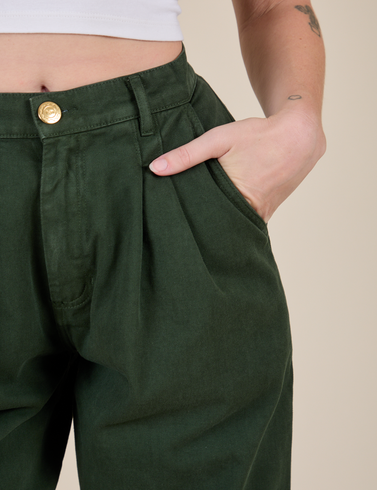 Close up of Alex&#39;s hand in the front pocket of Heavyweight Trousers in Swamp Green