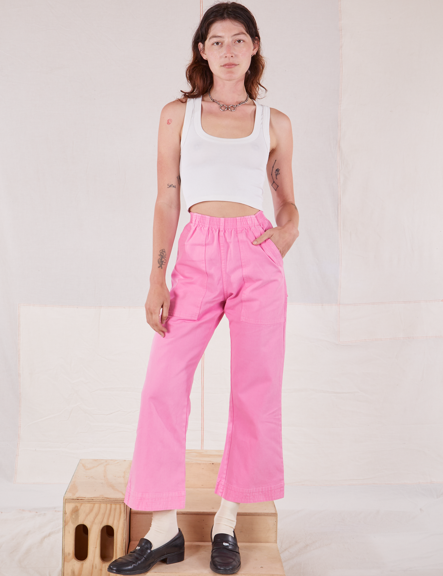 Alex is wearing Action Pants in Bubblegum Pink and Cropped Tank in vintage tee off-white