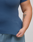 Close up of Juliet holding the Baby Tee in French Blue bottom hem