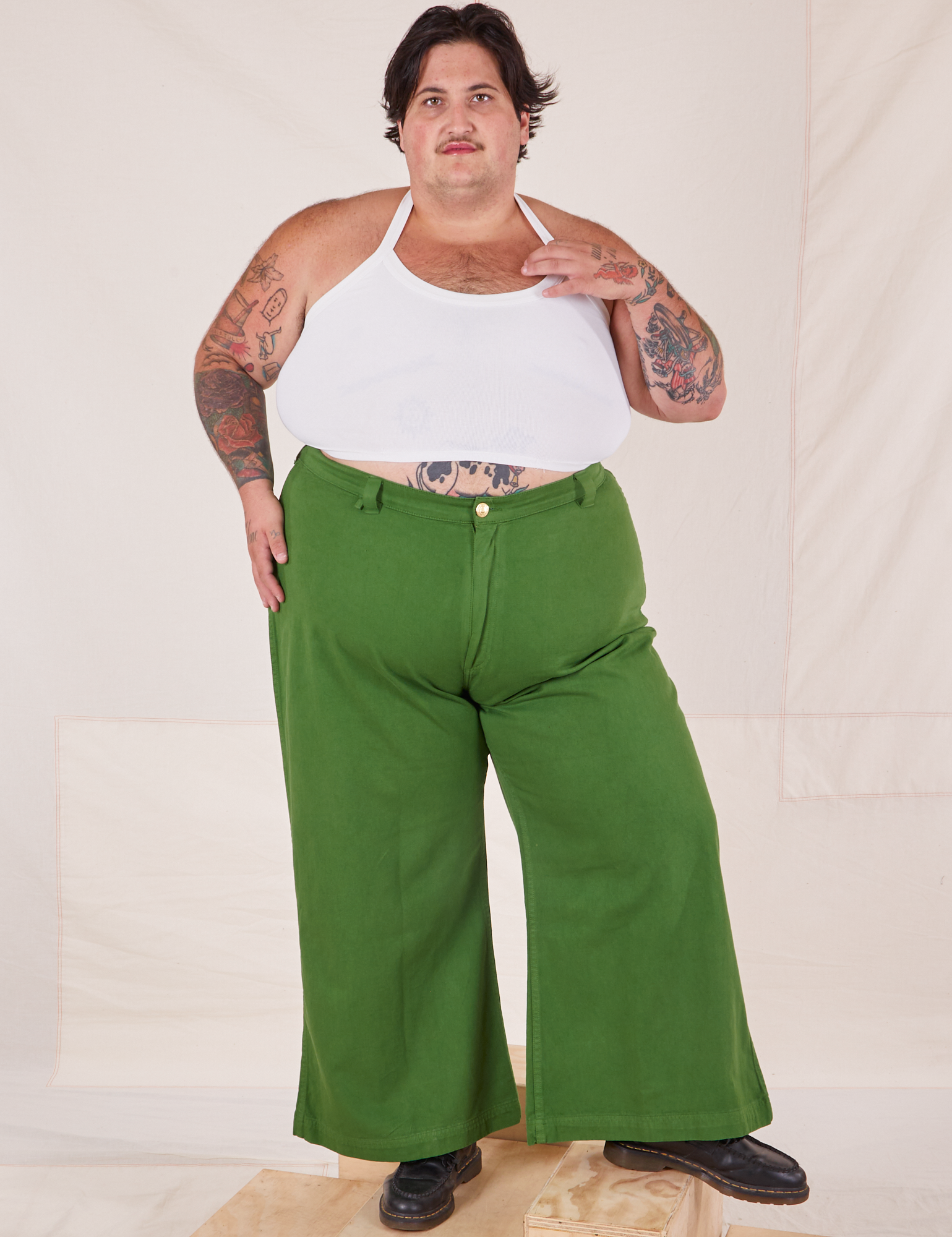 Sam is wearing Bell Bottoms in Lawn Green and vintage off-white Halter Top