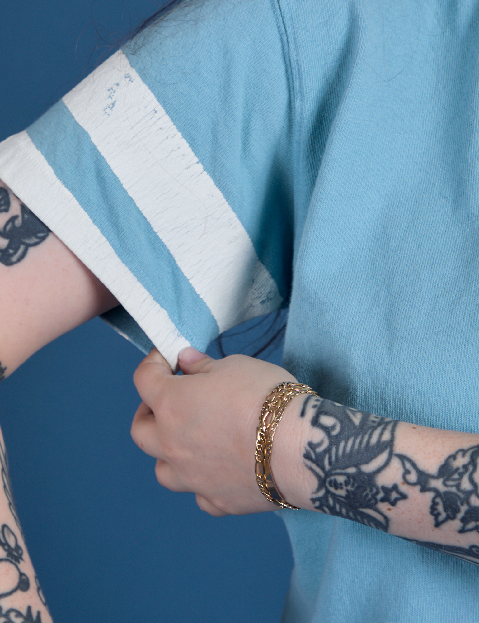 Painted Burly Tee in Baby Blue close up of sleeve with two painted white stripes