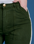 Close up of Sydney's hand in the front pocket of Painted Work Pants in Evergreen