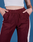 Painted Action Pants in Red Wine front close up with Alex's hand in both pockets