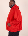 Oversized Hoodie in Mustang Red side view on Elijah