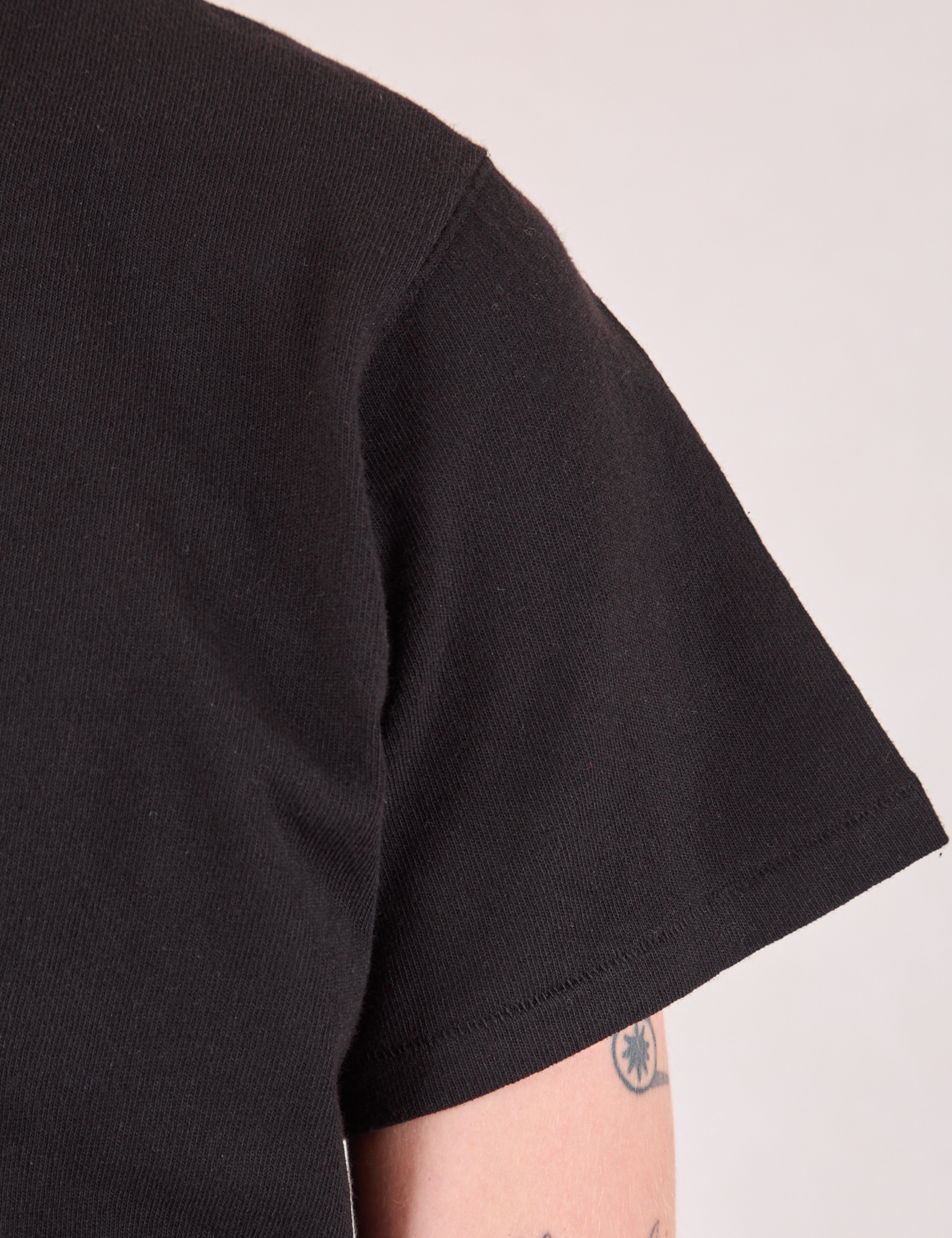 Burly Tee in Basic Black sleeve close up on Quinn