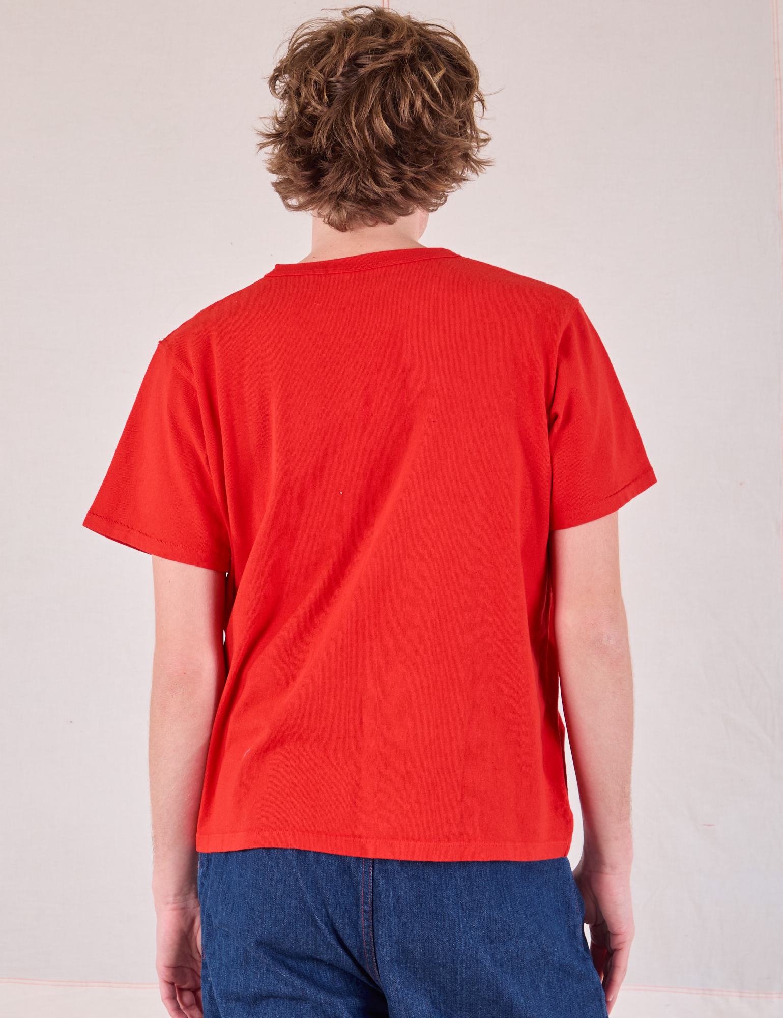 Burly Tee in Mustang Red back view on Quinn