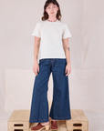 Alex is wearing Burly Tee in Vintage Tee Off-White and dark wash Denim Wide Leg Trousers