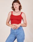 Alex is wearing Cropped Cami in Mustang Red and light wash Frontier Jeans