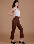 Side view of Carpenter Jeans in Fudgesicle Brown and Cropped Tank in Vintage Tee Off-White