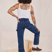Back view of Carpenter Jeans in Dark Wash and vintage off-white Cami worn by Jesse