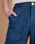 Close up of Quinn's hand in the front pocket of Carpenter Jeans in Dark Wash