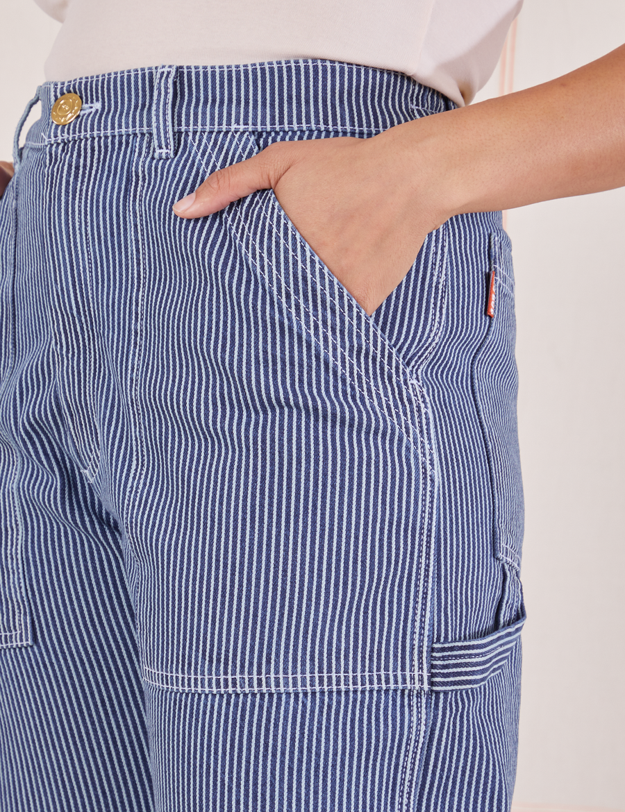 Carpenter Jeans in Railroad Stripes front pocket close up. Tiara has her hand tucked into the pocket.